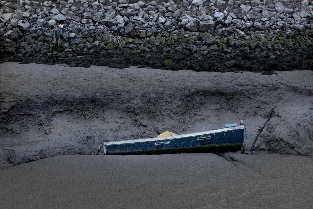 Blue boat on mud at Greenfild Dock, Dee Estuary