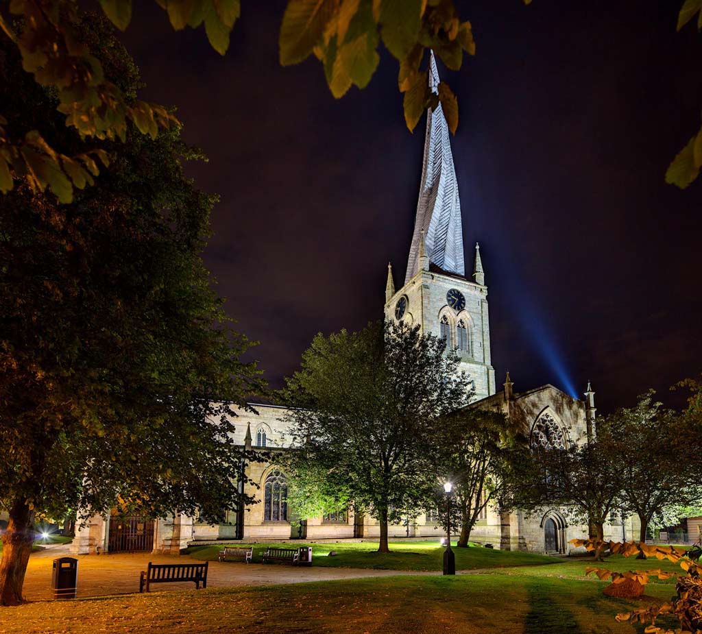 Crooked-Spire at night framed by autumn leaves
