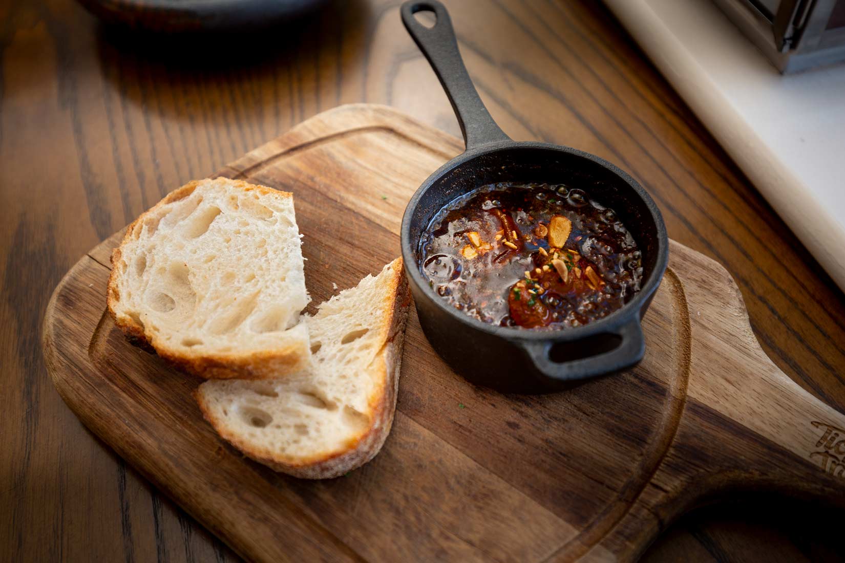 Bread and iron skillet in a cheese board with dramtic lighting