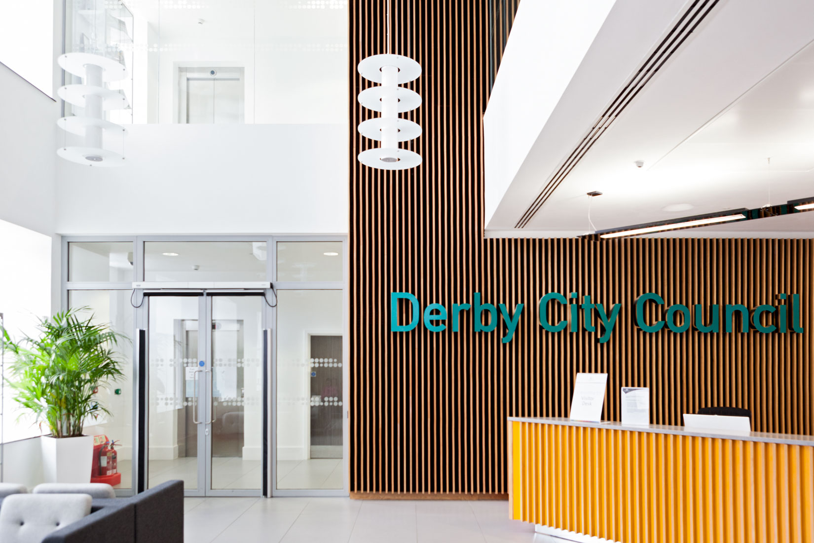 Interior Photograph of Derby City Council Reception double height space and vertical wooden slats floor to ceiling