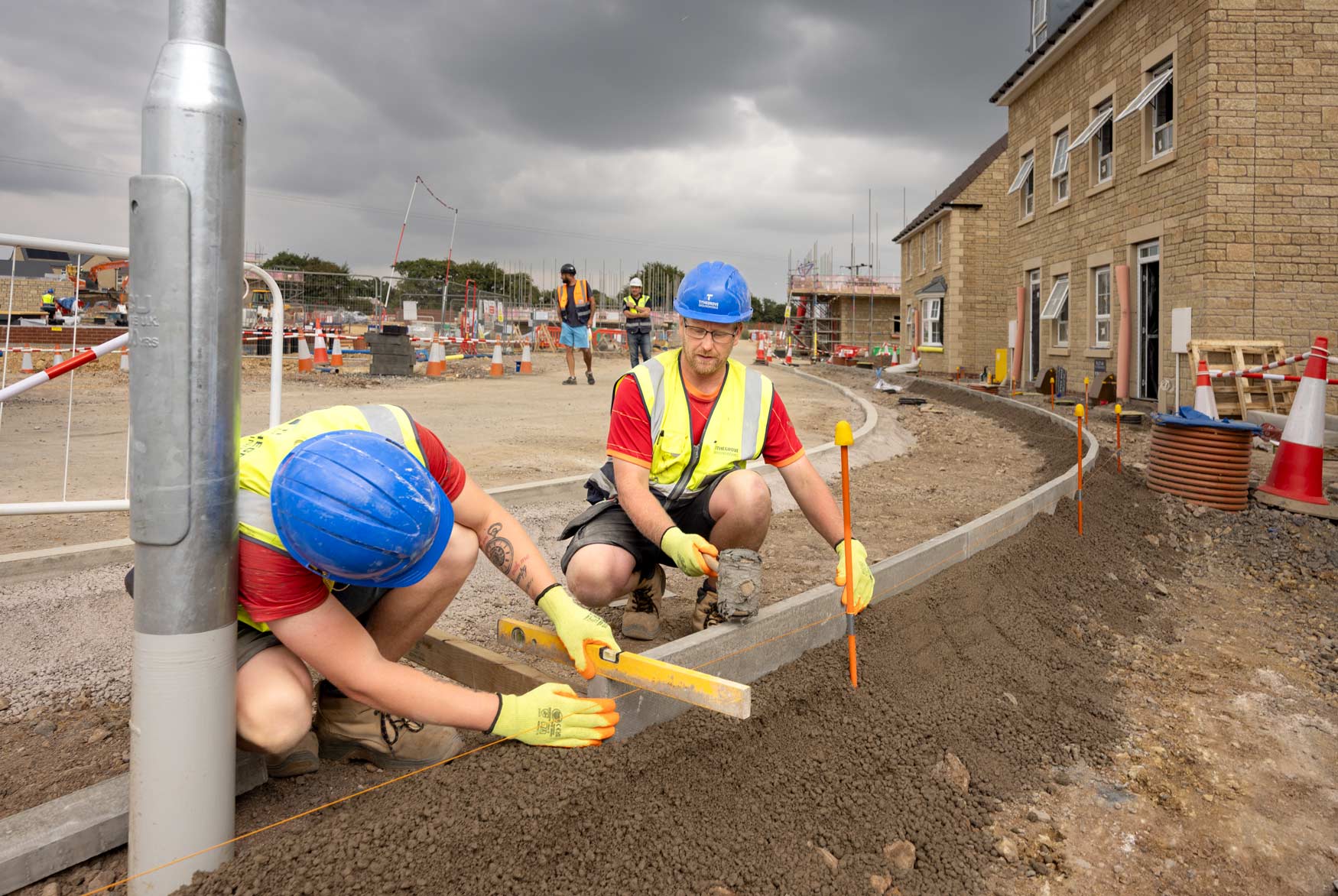 Construction photographer capturing a housing development road edging installation