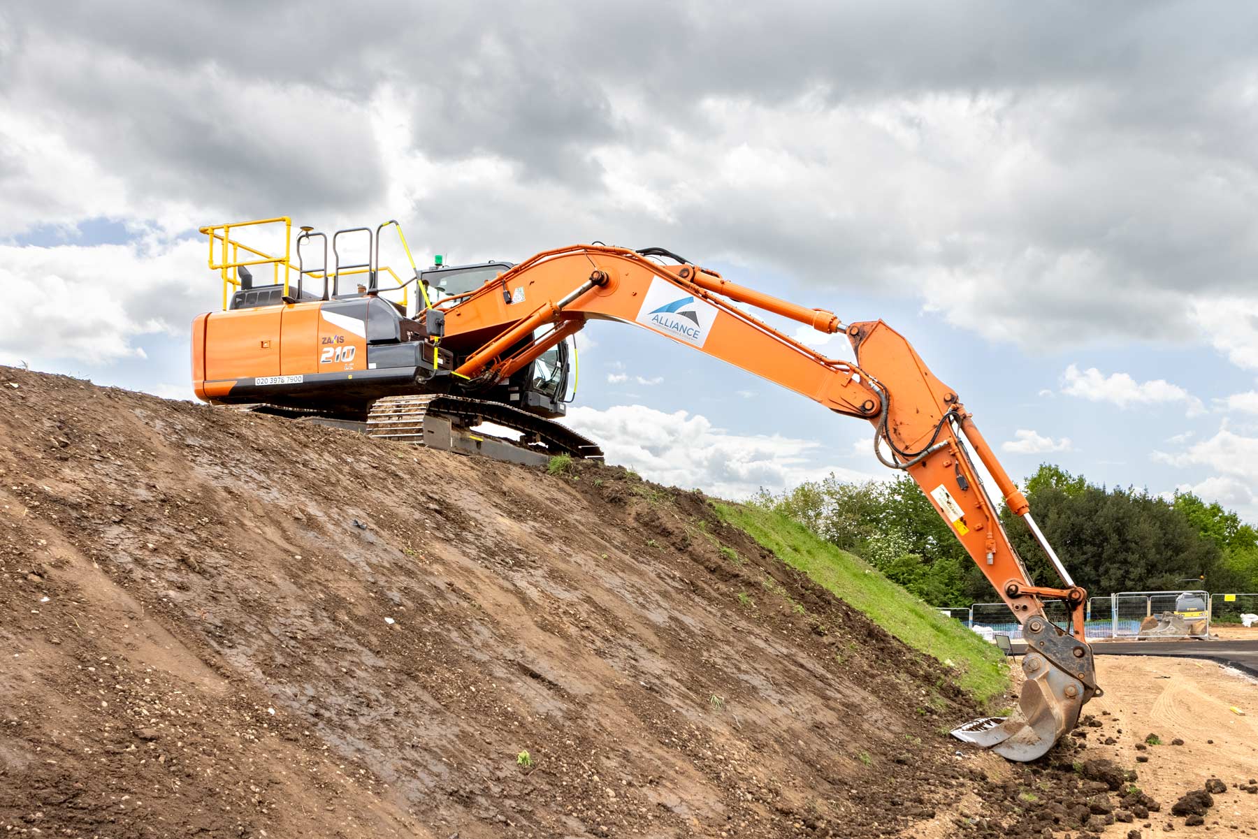 Plant Machinery, the the Hitachi Zaxis 210 at the top of a bank at full stretch